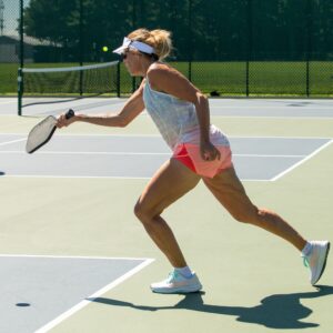 Pickleball is played on a smaller court than tennis, with a solid paddle made of wood or plastic or higher quality composite materials and plastic wiffle balls.