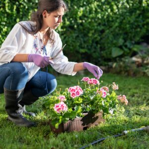 Image of a person using proper body mechanics while gardening.