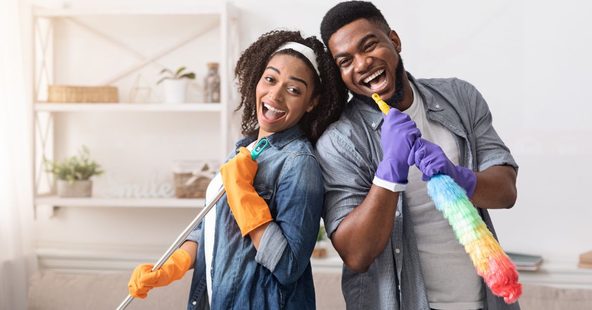 Couple posing while spring cleaning, for a blog post promoting tips for a pain free spring cleaning session by Sport & Spine Physical Therapy in Wittenberg, Wisconsin.