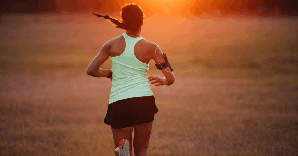 woman running in central Wisconsin to promote the importance of stretching before a run to help with hip flexor issues