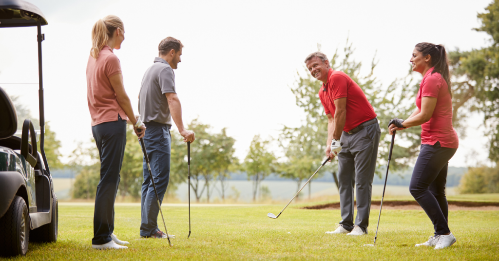 Friends playing golf after stretching to optimize their game.
